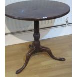 A Georgian mahogany tripod table with a single piece top on a wrythern turned column and splayed
