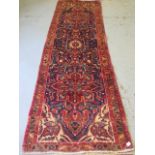 A hand knotted woollen Kashan rug, 3.10m x 1.07m