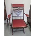 An upholstered folding steamer chair
