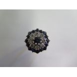 A hallmarked 18ct white gold diamond and sapphire cluster ring, head size 19mm, ring size P,