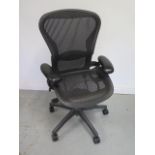A Herman Miller Aeron office chair with lumbar support in black in good condition