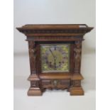 A walnut figural striking mantle clock, 40cm x 36cm, with key in running order