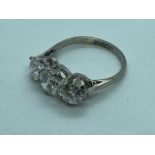 A stunning three stone diamond platinum ring comprising of three round brilliant cut diamonds,
