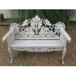 A good cast iron acorn and leaf decorated garden bench with leopard head arms, 95cm tall x 150cm x