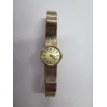 A ladies 9ct gold manual Tissot watch on a hallmarked bracelet, approx 23 grams, 17mm case, running,