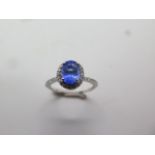 An 18ct white gold tanzanite and diamond ring, approx 0.50ct, ring size O, in good condition,