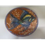 A terracotta fish decorated dish, 31cm diameter, signed to reverse, in good condition, some crazing