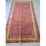 A hand knotted woollen Araak rug, 243m x 1.30m