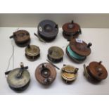 Ten assorted brass and wooden vintage fishing reels, largest 10cm, all unnamed