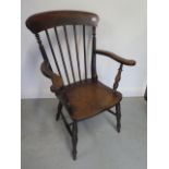 A late 19th century elm stickback elbow chair in polished condition
