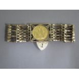 A 9ct yellow gold gatelink bracelet with a George V sovereign dated 1912, approx 25 grams, generally