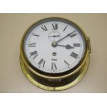 An 8 day brass ships clock, 20cm diameter, in working order