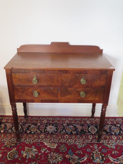 A 19th century mahogany side table with two short drawers over a single long drawer on turned reeded