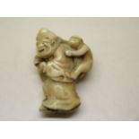 A 19th century Japanese carved ivory netsuke - man and monkey, 4cm tall, in good condition