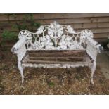 A good cast iron acorn and leaf decorated garden bench with leopard head arms, 95cm tall x 150cm x