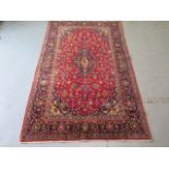 A hand knotted woollen Kashan rug, 2.15m x 1.30m