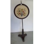 A 19th century rosewood platform base pole screen, 139cm tall, some wear / splitting to brass work