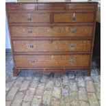 A Georgian oak and mahogany five drawer chest on bracket feet, in need of some restoration, 108cm