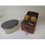 A silver top glass tidy, top approx 1.9 troy oz and a leather cased two bottle cologne scent set