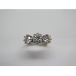 A hallmarked 18ct white gold three stone diamond ring, the outer diamonds approx 0.55ct each, the