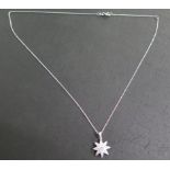 A white gold diamond encrusted star pendant and chain, approx 0.75ct, chain approx 18" long, pendant