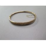 A 9ct yellow gold hollow bangle approx 4.4 grams, some denting but clasp good