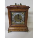 A nice quality bracket clock by W and H oak case with lion head decoration brass dial with silver