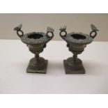 A pair of Georgian bronze urns of small proportions with butterfly handles, 10cm tall