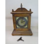 A walnut inlaid mantle clock with a W&H Sch movement, striking on two gongs, 34cm tall, with key,