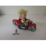 A Schuco tinplate clockwork Mirako Peter 1013 motorcycle, 13cm long, with key, working and generally