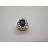 A hallmarked 18ct yellow gold sapphire and white stone ring, size J, approx 5.5 grams, some