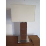 A designer chrome and leather effect table lamp, 85cm tall