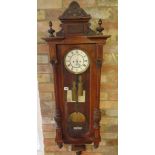 A walnut double weight Vienna wall clock, 130cm tall, in running order