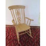 A Victorian style beech rocking armchair