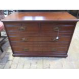 A circa 1900s walnut chest of two over two graduated oak lined drawers, brass drop handles on a