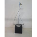 An Art Deco style chrome sailing boat on ebonised wooden stand, 40cm tall