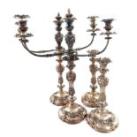 A set of four early 19th century old Sheffield plated candlesticks with two pairs of three light