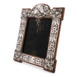 An Edwardian silver photograph frame, by J Aitkin & Son, Birmingham 1904, shaped upright rectangular