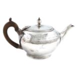 A George III silver tea pot, by Thomas Law, Sheffield 1802, circular form, with an engraved Greek