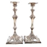 A pair of George III silver candlesticks, probably by John Carter, London 1770, the bases also