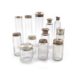 A collection of silver-mounted glass toilet bottles and jars, various dates and makers, various