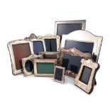 A collection of twelve silver photograph frames, various dates and makers, various shapes, some with