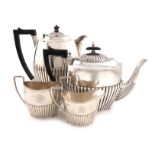 A late-Victorian matched four-piece silver tea set, by J and W Deakin, Sheffield 1892, the hot water