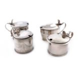 A collection of four antique silver mustard pots, comprising: a George III one of oval form, by