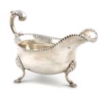 A George III silver sauce boat, probably by William Skeen, London 1765, oval form, leaf capped