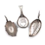 A small collection of three antique silver caddy spoons, comprising: one of leaf form, by Joseph