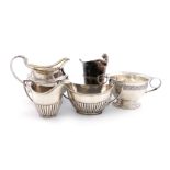 A mixed lot of silver items, various dates and makers, comprising: an Edwardian silver cream jug,