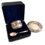 A three-piece Edwardian Arts and Crafts silver-gilt christening set, by Nathan and Hayes, Chester