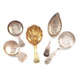 A collection of five antique silver caddy spoons, various dates and makers, including: a George