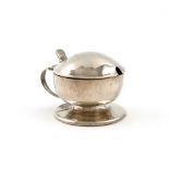 By Liberty and Co. an Art Nouveau silver mustard pot, Birmingham 1918, circular form, spot-